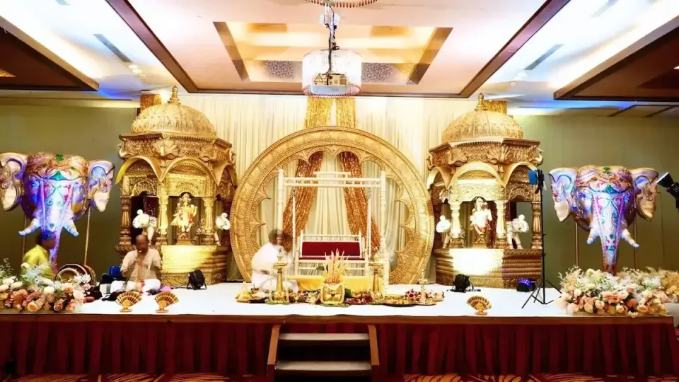 A gold carved wedding stage styled by Alangkaar